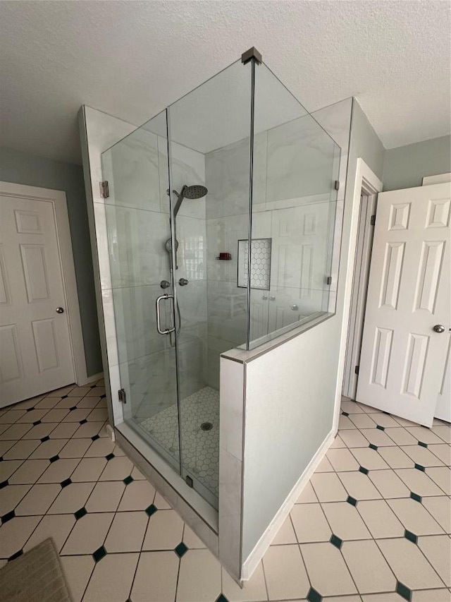 417 Akaloa Dr, Bastrop, TX 78602 - full bath with baseboards, a stall shower, tile patterned floors, and a textured ceiling