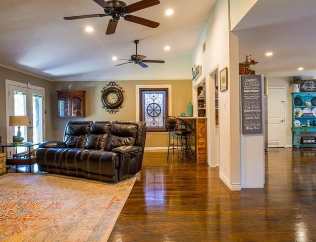 living room featuring recessed lighting, baseboards, and wood finished floors