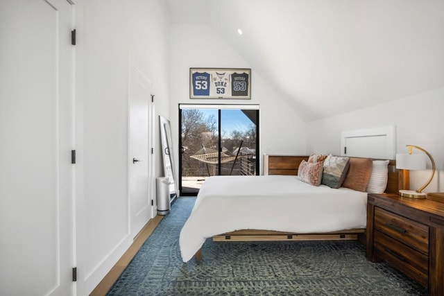 bedroom featuring lofted ceiling and access to exterior