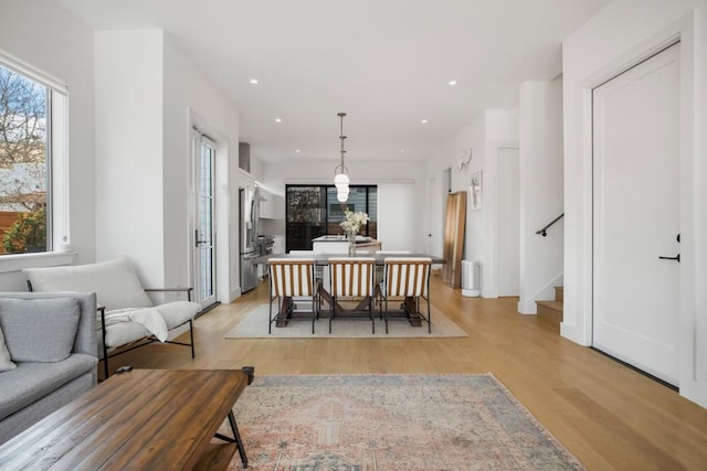 dining space featuring stairs, recessed lighting, and light wood-style floors