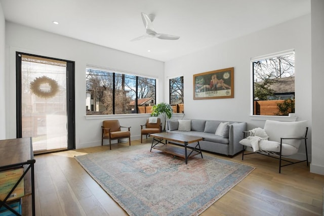 living area with ceiling fan, recessed lighting, wood finished floors, and baseboards