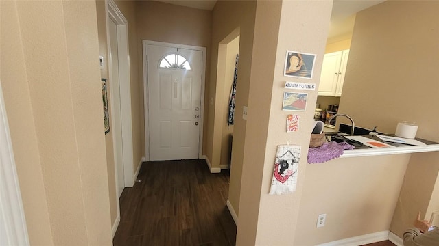 interior space with baseboards and dark wood-type flooring