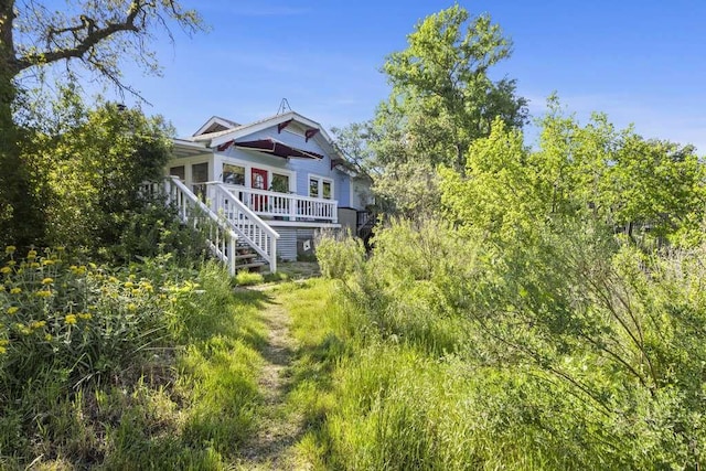 rear view of house with a deck and stairway