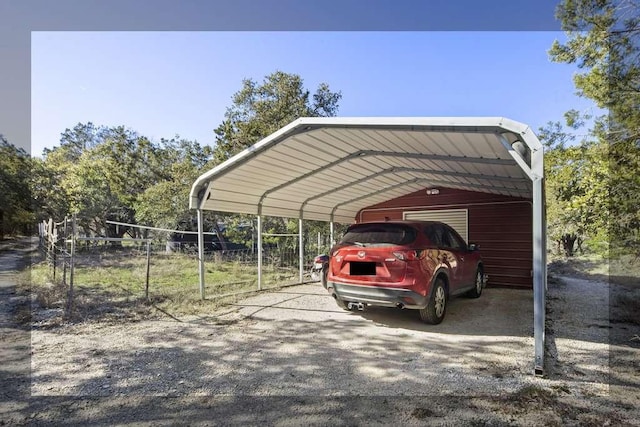 view of car parking featuring a carport and fence