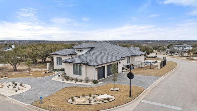 1000 Flint Ridge Trl, Georgetown, TX 78628 - view of front of house featuring gravel driveway, an attached garage, and a tile roof