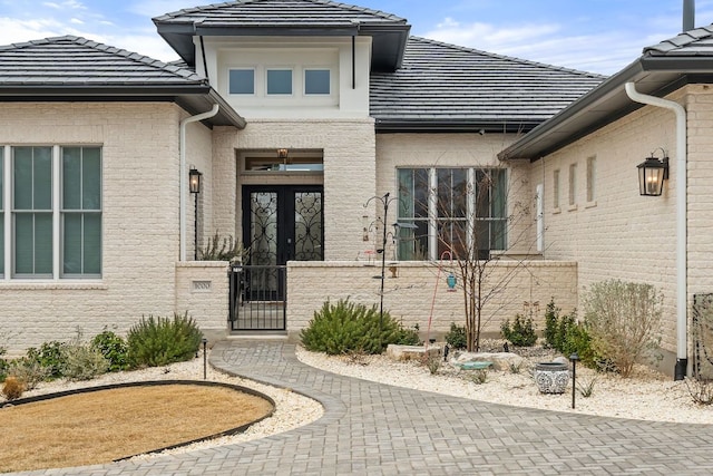 1000 Flint Ridge Trl, Georgetown, TX 78628 - entrance to property with a tiled roof, a gate, brick siding, and fence