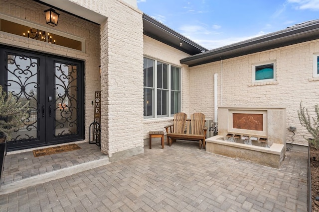1000 Flint Ridge Trl, Georgetown, TX 78628 - doorway to property with french doors, a fireplace, and a patio area