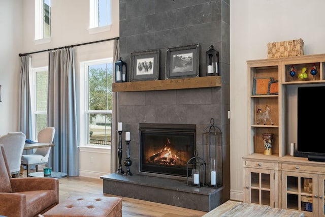 1000 Flint Ridge Trl, Georgetown, TX 78628 - living area featuring a fireplace, wood finished floors, and baseboards