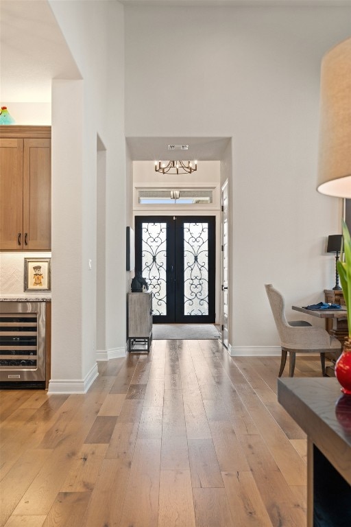 1000 Flint Ridge Trl, Georgetown, TX 78628 - entryway featuring wine cooler, light wood-type flooring, a chandelier, and baseboards