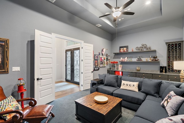1000 Flint Ridge Trl, Georgetown, TX 78628 - carpeted living area with a ceiling fan and a raised ceiling