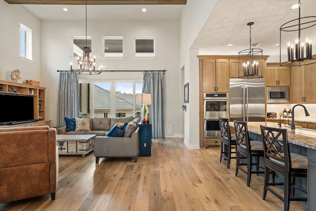 1000 Flint Ridge Trl, Georgetown, TX 78628 - living room featuring a chandelier, light wood-style floors, recessed lighting, and baseboards