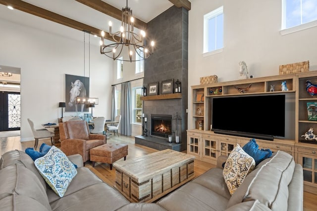 1000 Flint Ridge Trl, Georgetown, TX 78628 - living area featuring a high ceiling, a chandelier, wood finished floors, and a fireplace