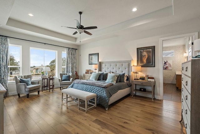 1000 Flint Ridge Trl, Georgetown, TX 78628 - bedroom with a tray ceiling, wood-type flooring, recessed lighting, baseboards, and ceiling fan