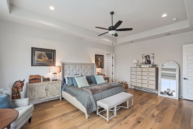1000 Flint Ridge Trl, Georgetown, TX 78628 - bedroom featuring a tray ceiling, wood finished floors, recessed lighting, and ceiling fan