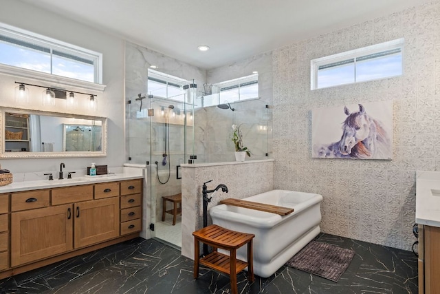 1000 Flint Ridge Trl, Georgetown, TX 78628 - full bathroom with vanity, a shower stall, a soaking tub, marble tiled flooring, and healthy amount of natural light