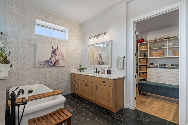 1000 Flint Ridge Trl, Georgetown, TX 78628 - full bath featuring marble tiled floors, vanity, and a freestanding tub