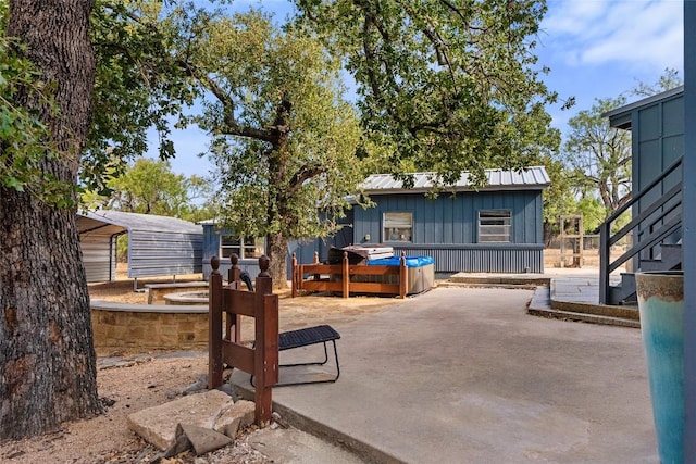 exterior space with an outbuilding and a hot tub