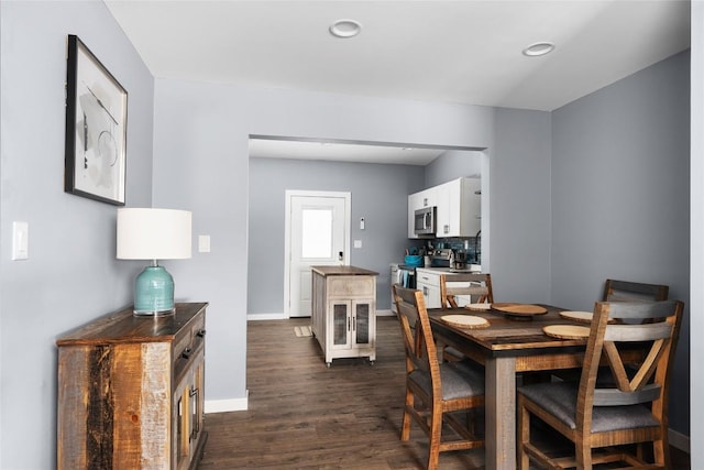 dining room featuring baseboards, dark wood-style flooring, and recessed lighting