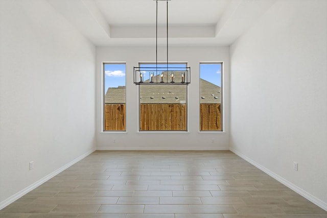 1832 Camay St, Leander, TX 78641 - unfurnished dining area featuring healthy amount of natural light, a raised ceiling, and light wood finished floors