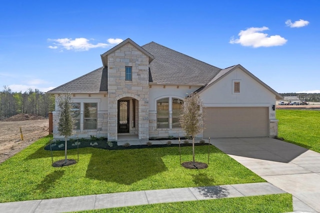 1832 Camay St, Leander, TX 78641 - french country style house featuring stone siding, a shingled roof, an attached garage, concrete driveway, and stucco siding