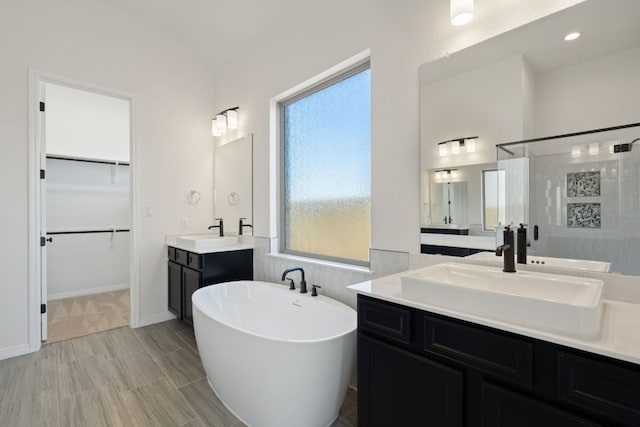 1832 Camay St, Leander, TX 78641 - full bath with a shower stall, a freestanding tub, two vanities, and a spacious closet