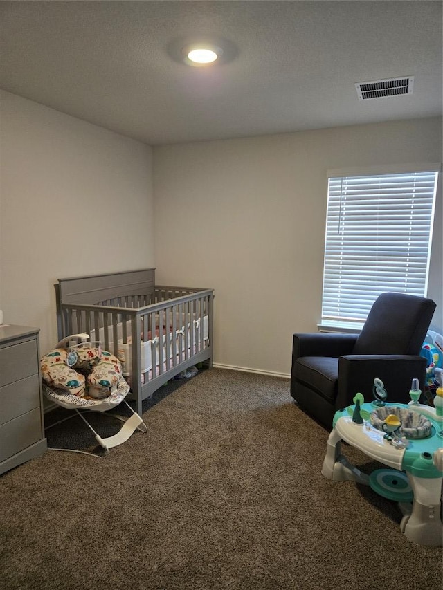 carpeted bedroom with visible vents and baseboards