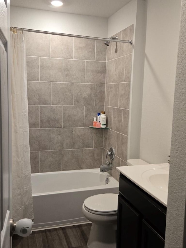 full bathroom with vanity, shower / tub combo, wood finished floors, and toilet