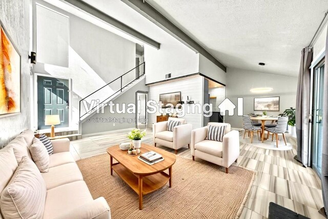 living area with stairs and a textured ceiling