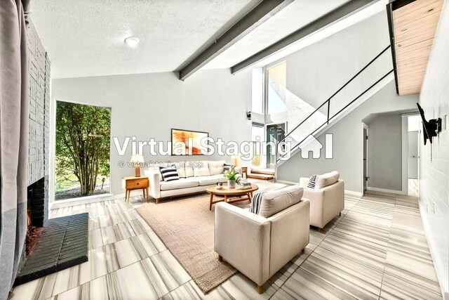 living room featuring a brick fireplace, a textured ceiling, light tile patterned flooring, and beamed ceiling