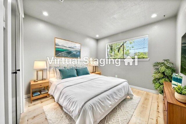 bedroom with light wood-style floors, baseboards, recessed lighting, and a textured ceiling