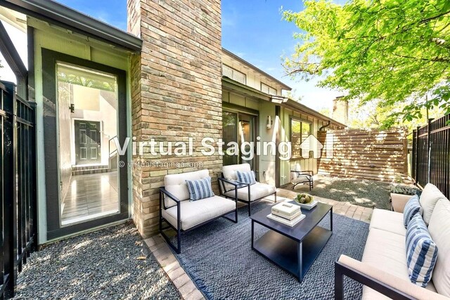 view of patio / terrace featuring an outdoor living space and fence