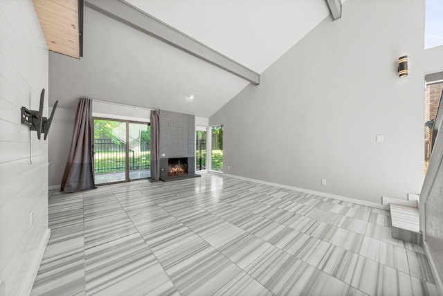 unfurnished living room with high vaulted ceiling, beam ceiling, a fireplace, baseboards, and light tile patterned floors