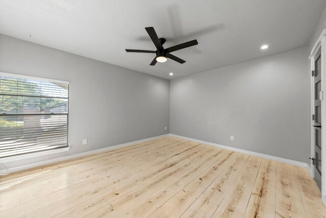 empty room featuring ceiling fan, recessed lighting, baseboards, and wood finished floors