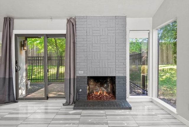 unfurnished living room featuring a brick fireplace