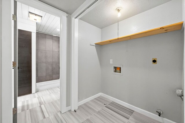 laundry room with hookup for a washing machine, baseboards, and electric dryer hookup
