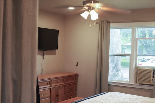 bedroom featuring cooling unit and a ceiling fan