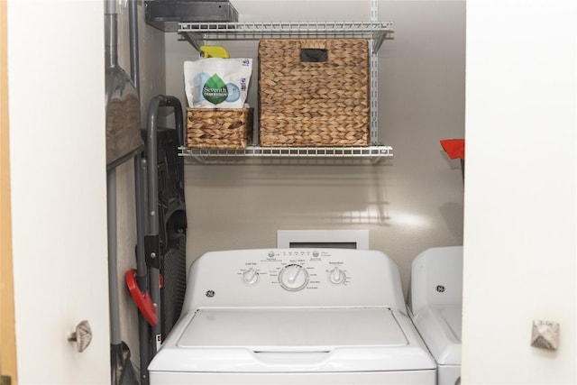 washroom featuring laundry area and washing machine and dryer