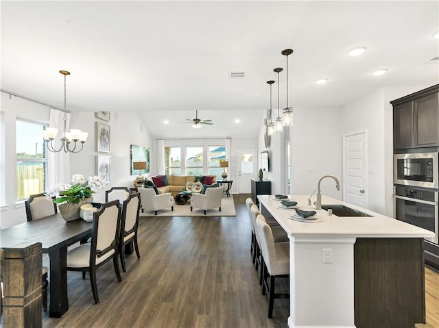 205 Bluff Creek Ln, Georgetown, TX 78628 - kitchen with stainless steel appliances, dark wood-type flooring, light countertops, healthy amount of natural light, and recessed lighting
