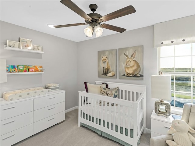 205 Bluff Creek Ln, Georgetown, TX 78628 - bedroom with carpet floors, a crib, and a ceiling fan