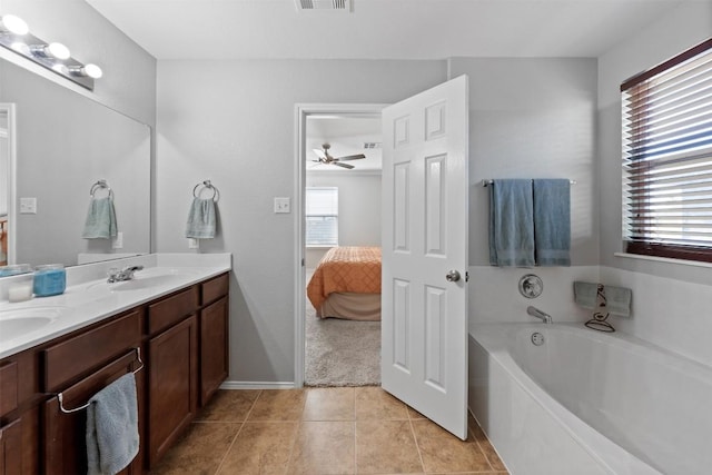 ensuite bathroom with double vanity, visible vents, tile patterned floors, ensuite bathroom, and a garden tub