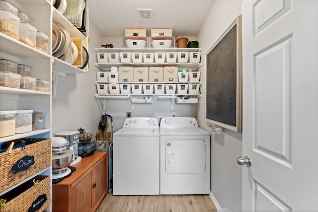 laundry room with light wood-type flooring, laundry area, and washer and dryer