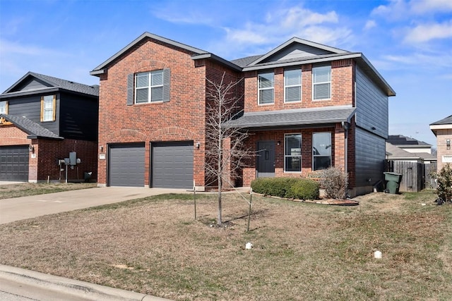 traditional home with a garage, driveway, brick siding, and a front yard