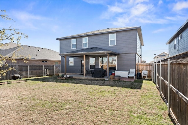 back of house featuring a patio, a yard, and a fenced backyard