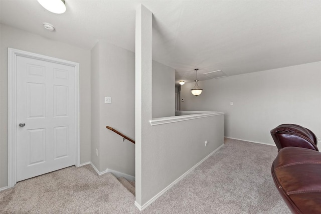 sitting room with carpet flooring, an upstairs landing, and baseboards