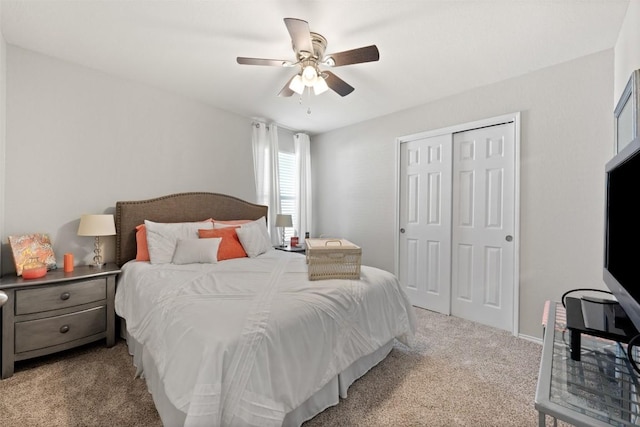 bedroom featuring light carpet, a closet, and a ceiling fan