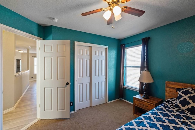 103 Ryan Cv, Hutto, TX 78634 - bedroom featuring a textured ceiling, a closet, and ceiling fan