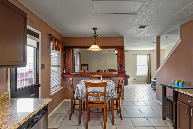 103 Ryan Cv, Hutto, TX 78634 - dining area with a textured ceiling, light tile patterned floors, and a ceiling fan
