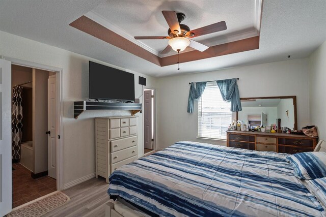 103 Ryan Cv, Hutto, TX 78634 - bedroom with a raised ceiling, ornamental molding, wood finished floors, a textured ceiling, and ceiling fan