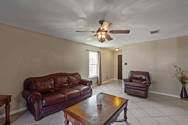 103 Ryan Cv, Hutto, TX 78634 - living room featuring light tile patterned flooring and ceiling fan