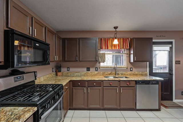 103 Ryan Cv, Hutto, TX 78634 - kitchen with appliances with stainless steel finishes, healthy amount of natural light, and light tile patterned flooring